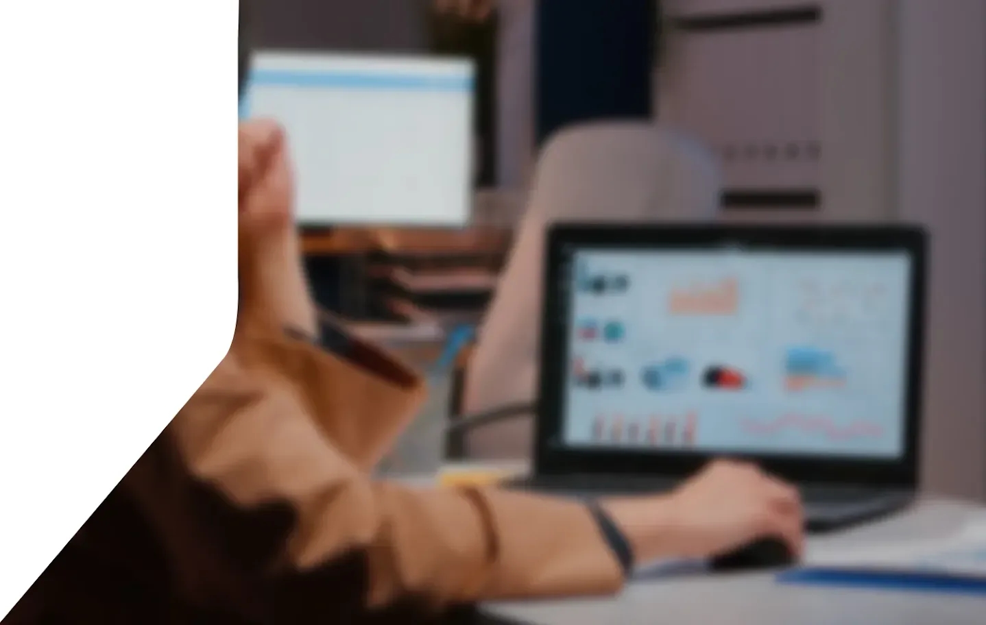 A person working late at a laptop showing call analytics charts